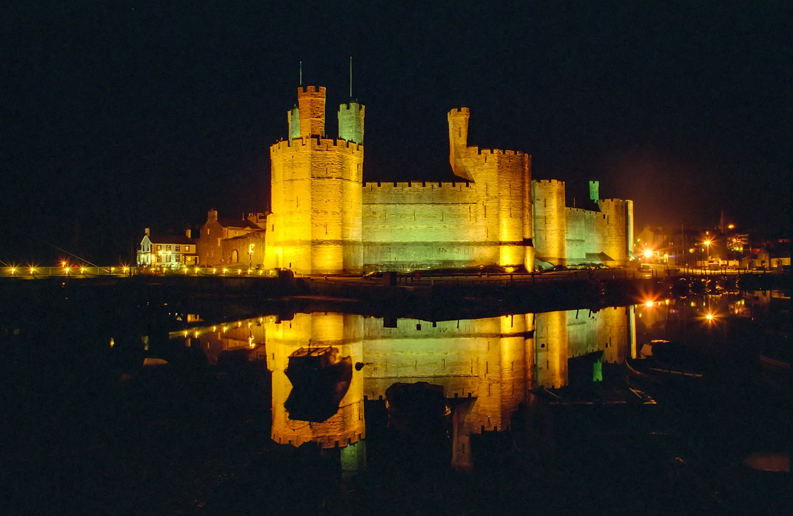 Caernarfon's Castle brown concrete castle on water during night time