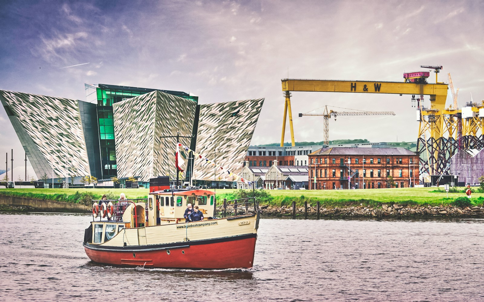 Belfast red and white boat on water near green and white building during daytime