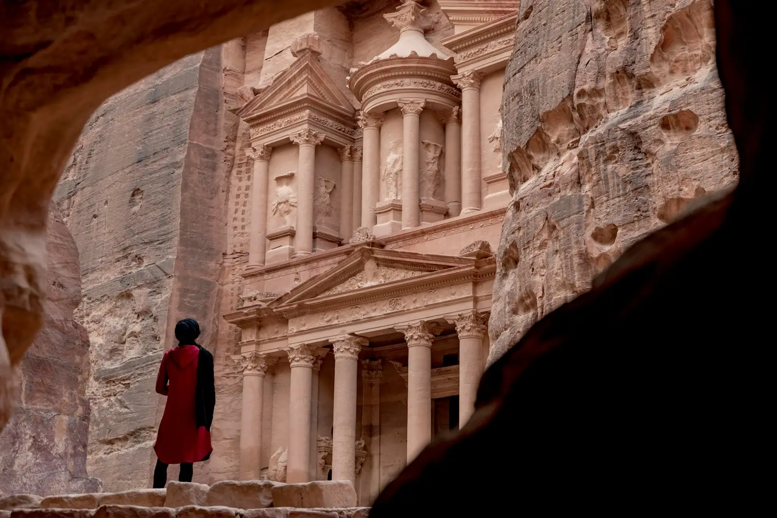 Petra dead sea woman in red coat standing in front of white concrete building during daytime