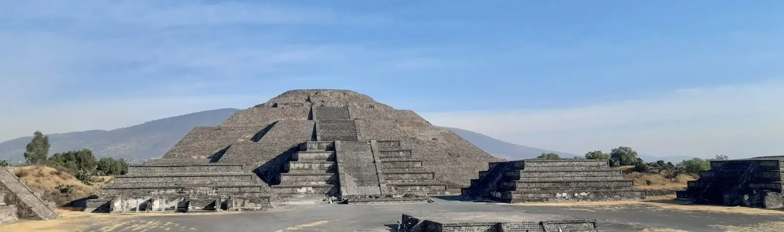 a hot air balloon flying over a pyramid