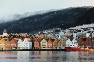 Bergen houses near body of water and mountain during daytime